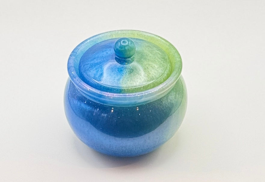 Mermaid Lagoon lidded resin jar open from above, showing glitter interior and domed lid