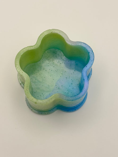 Mermaid Lagoon clover resin dish from above, showing sage green rim and ocean blue glitter interior