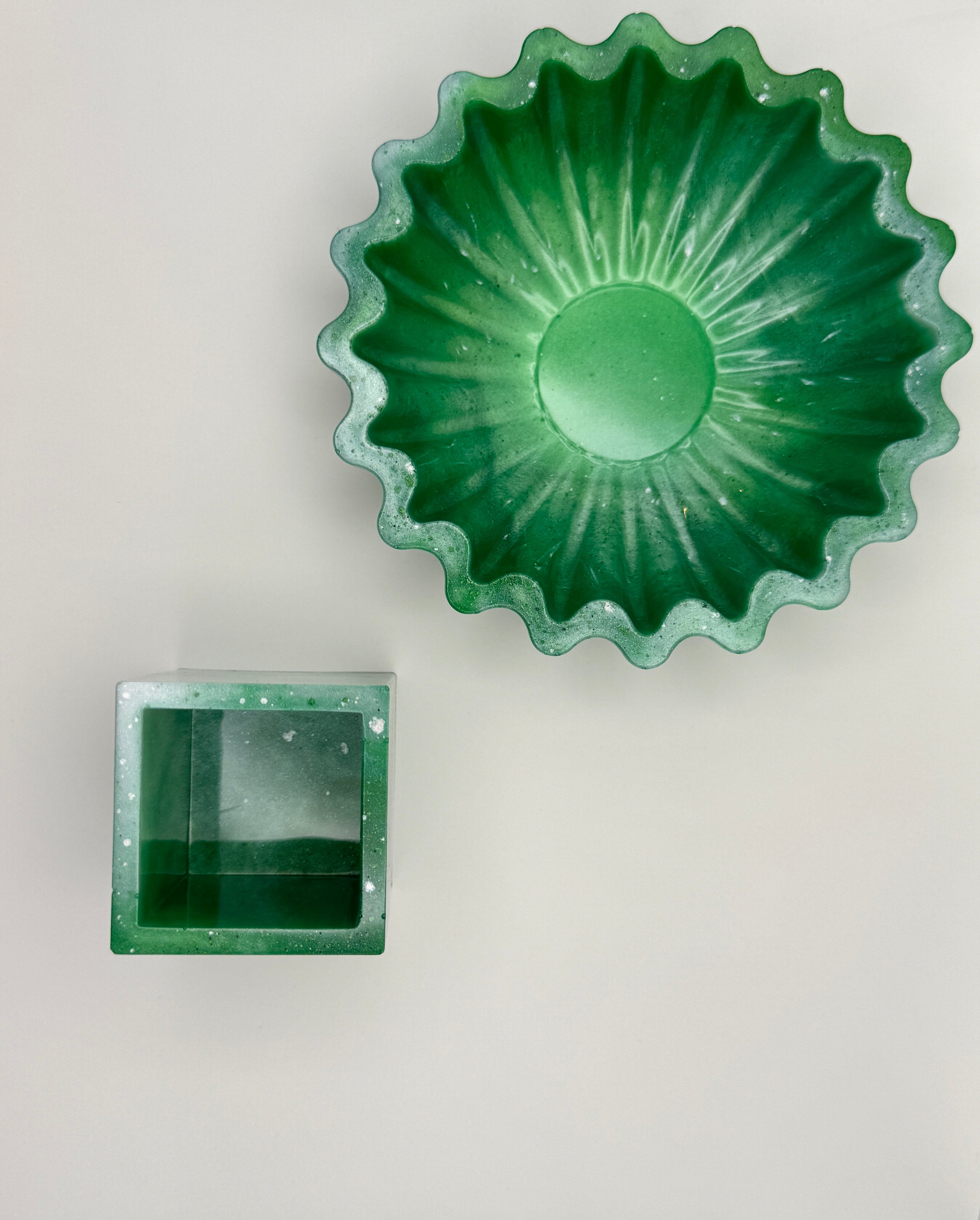 Emerald green resin bowl and cube vessel set, top-down view